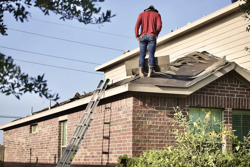 Professional roofer working on a residential roof in Rancocas